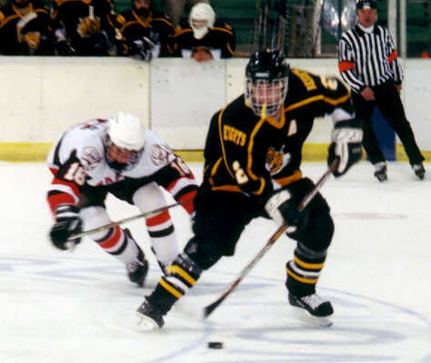 Brendon Benner keeps the puck away from Padua.