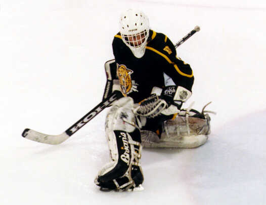 A Shaker shot sails wide of Heights' goaltender Ben Gaglioti.
