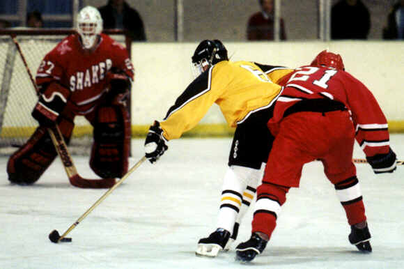 Jeff Houser holds off a defenseman on the way to his first of two goals against Shaker.