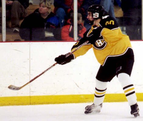 Justin Kalman clears the puck.