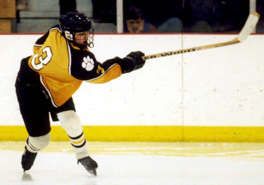 Jared Lavender sends the puck around the boards.