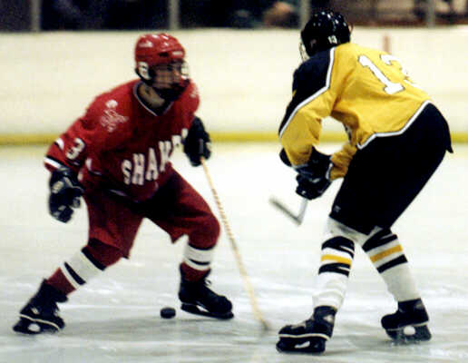 Chris Pesek slides the puck into Shaker's zone.