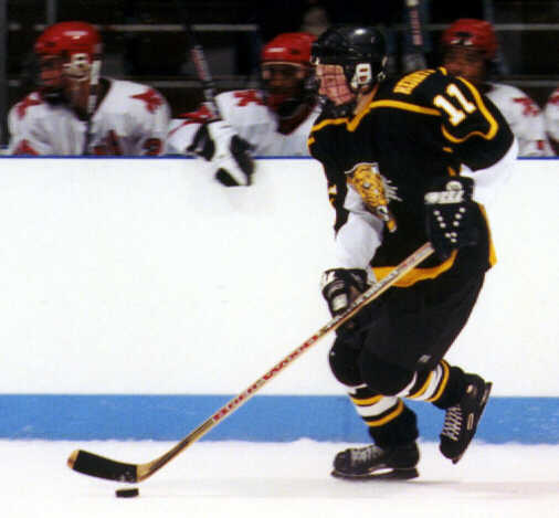 Joe Ross carries the puck past Shaker's bench.