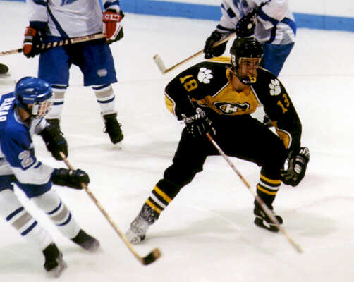 Mike Ruflin skates deep into Trinity territory.