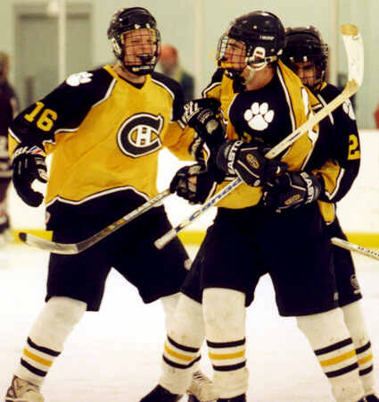 Milton Carter, Andrew West, and Lee Allen celebrate West's goal against Rocky River.