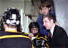 Coaches Kirk Guenther and Dave Boehm talk with the Tigers on the bench.