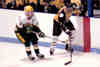 Carl Rose skates with a St. Edward Eagle.