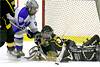 Daley Baker knocks the puck off the stick of a Lancer.