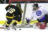 Ethan Farris tries to get his stick on a loose puck in the Gilmour crease.