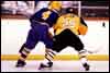 Lee Allen takes a Lakewood Ranger into the boards.