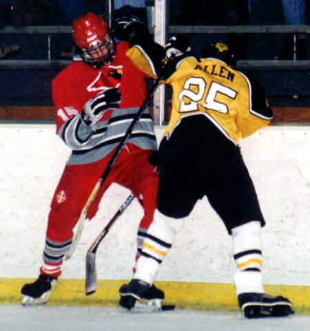 Lee Allen battles with a Mentor Cardinal for a loose puck.