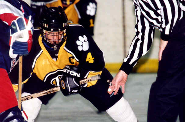 Brian Clark concentrates on winning a faceoff against Erie McDowell.