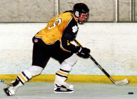 Milton Carter carries the puck through Erie McDowell's zone.