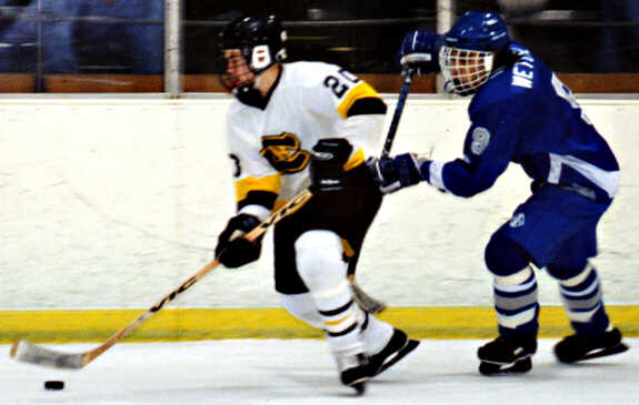Pat Collins outskates a Trinity Trojan.