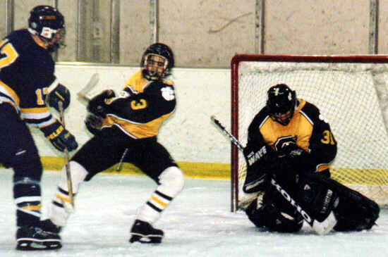Jared Lavender holds off an attacking forward as Matt Crowell grabs a rebound.