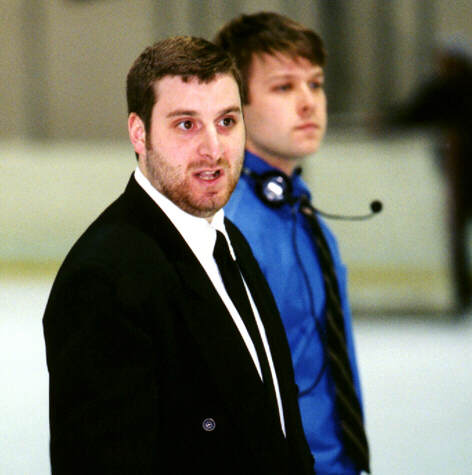 Coaches Kirk Guenther and Dave Boehm leave the ice after playing Trinity.