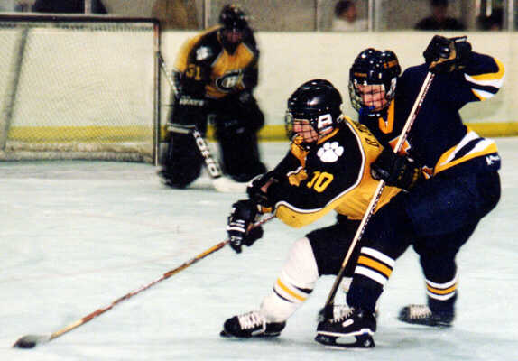 Doug Turner holds off a forechecking St. Ignatius Wildcat.