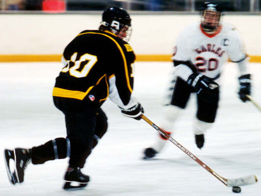 Doug Turner confronts a forechecking Eagle.