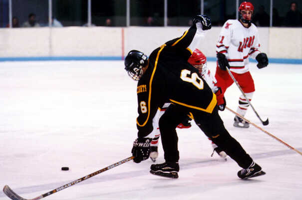 Andy West squeezes past a Shaker defenseman.