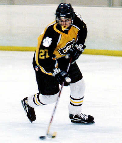 Andy West pivots around the puck.